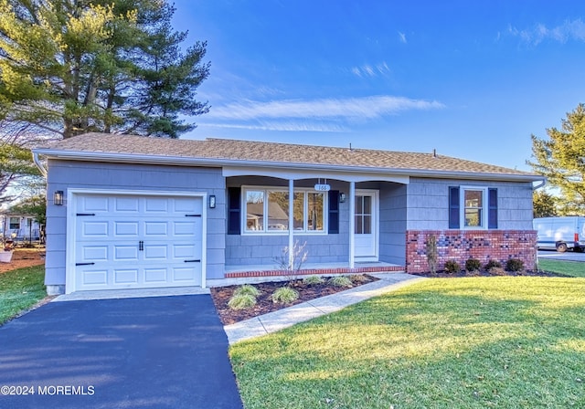 single story home featuring a garage and a front lawn