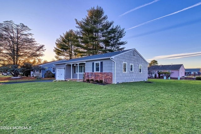 ranch-style house featuring a yard