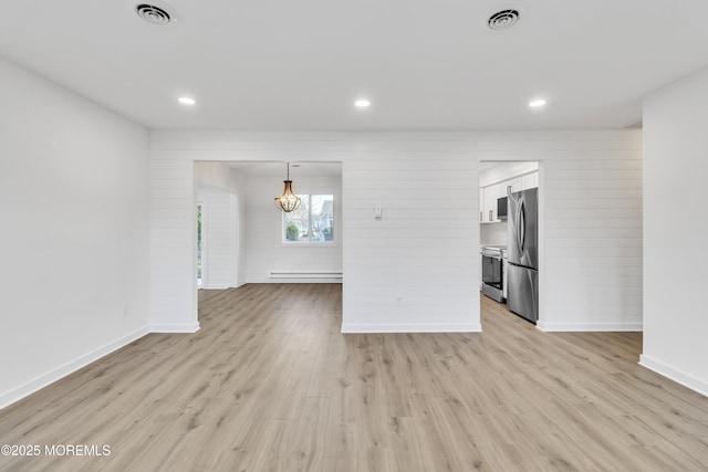 interior space featuring a baseboard radiator and light hardwood / wood-style flooring