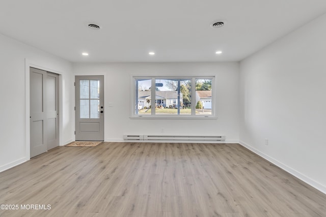 entrance foyer featuring light wood-type flooring and baseboard heating