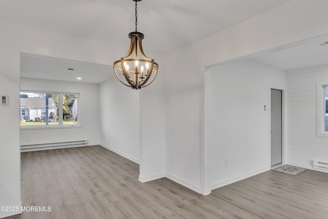 unfurnished room featuring a baseboard radiator, a chandelier, and light wood-type flooring