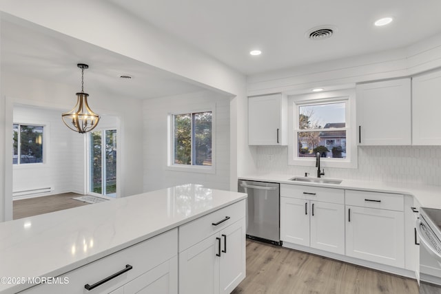 kitchen featuring sink, light stone counters, white cabinets, decorative light fixtures, and stainless steel dishwasher