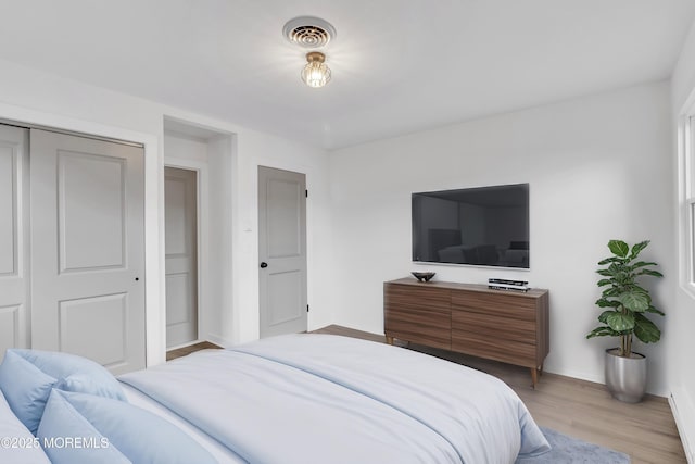 bedroom featuring light hardwood / wood-style flooring and a closet