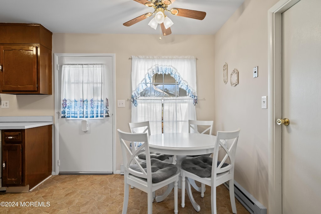 dining room with a baseboard radiator and ceiling fan