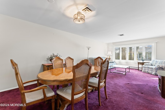 dining room featuring dark colored carpet and baseboard heating