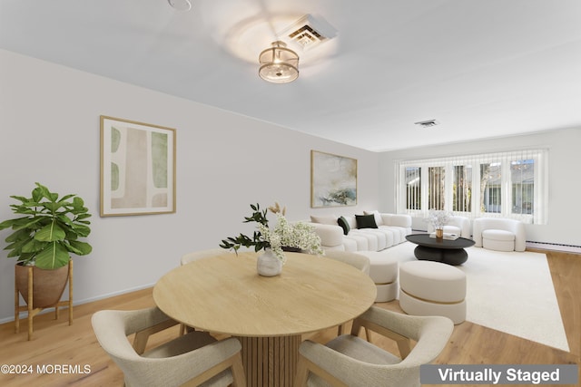 dining room with wood-type flooring