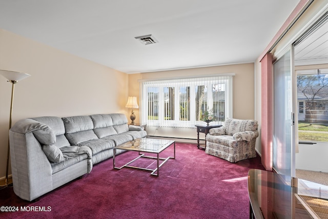 carpeted living room with baseboard heating