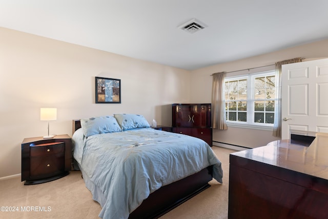 carpeted bedroom featuring baseboard heating