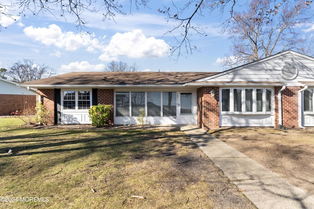 ranch-style home with a front lawn