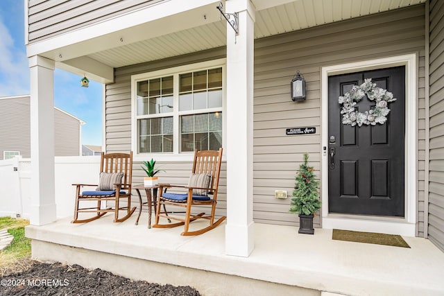 view of exterior entry featuring a porch