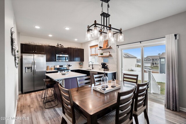 dining area featuring sink and light hardwood / wood-style flooring