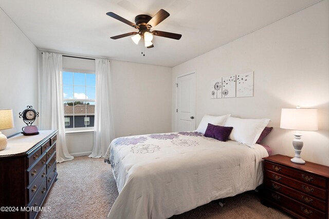 bedroom featuring ceiling fan and light colored carpet