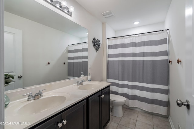 bathroom featuring tile patterned flooring, vanity, and toilet