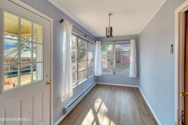 unfurnished sunroom with baseboard heating and a healthy amount of sunlight