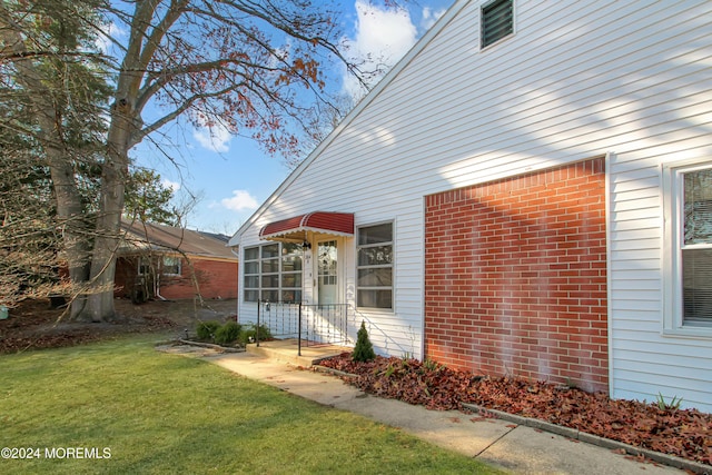 view of home's exterior featuring a yard