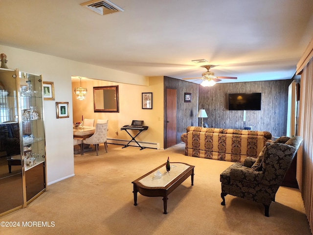 living room with ceiling fan with notable chandelier, light colored carpet, and a baseboard radiator