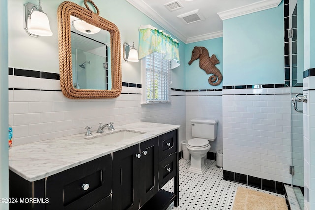 bathroom featuring crown molding, vanity, tile walls, and toilet