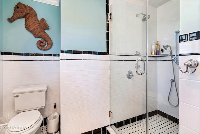 bathroom featuring walk in shower, tile walls, and toilet