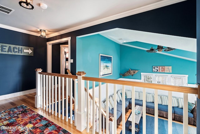 hall featuring hardwood / wood-style flooring and crown molding