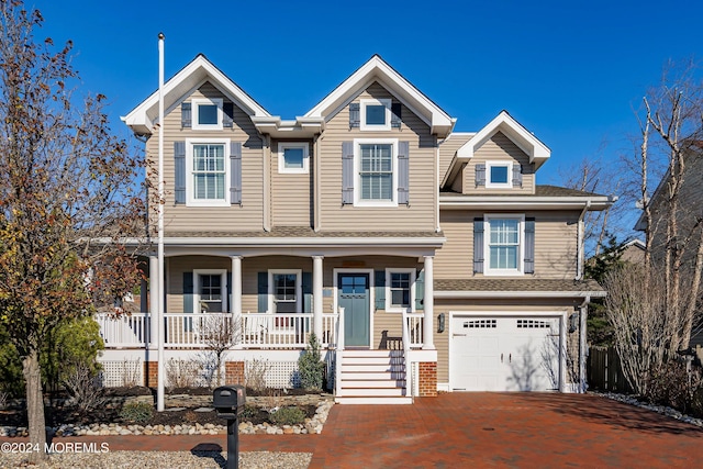 view of front of home with a porch and a garage