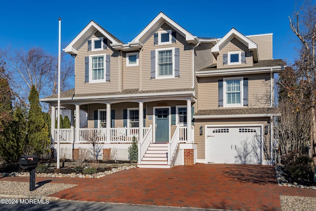 view of front facade featuring a porch and a garage