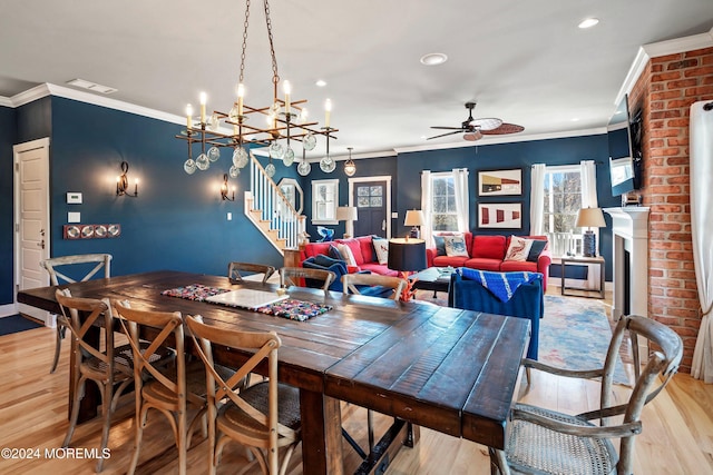 dining area with ceiling fan with notable chandelier, light hardwood / wood-style flooring, and crown molding