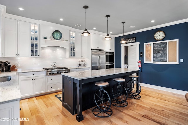 kitchen featuring a center island, white cabinetry, and appliances with stainless steel finishes