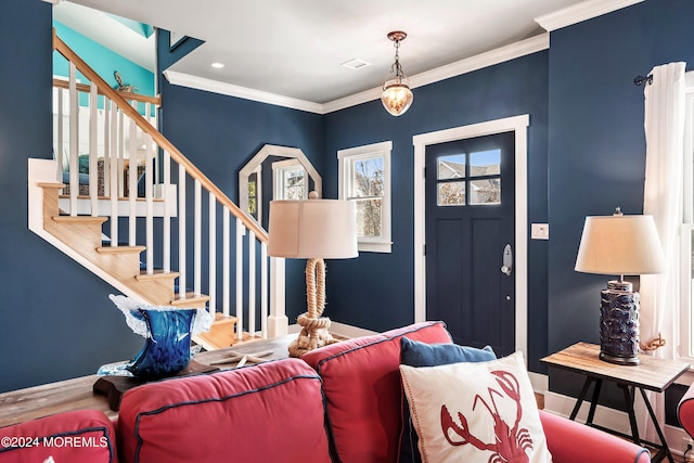 foyer entrance featuring hardwood / wood-style flooring and ornamental molding