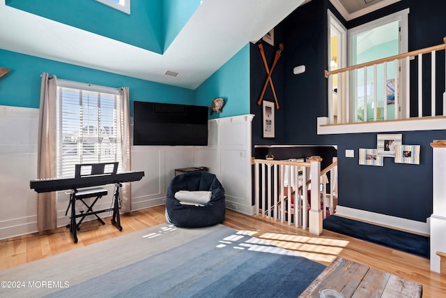 bedroom featuring hardwood / wood-style floors and vaulted ceiling