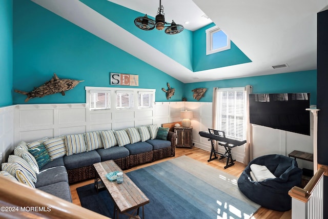 living room featuring a notable chandelier and light hardwood / wood-style flooring