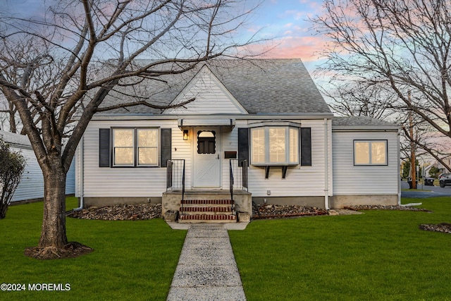 view of front of property with a lawn