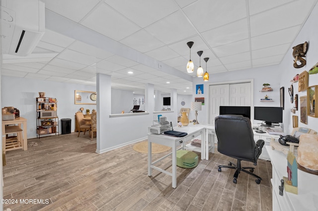 office space featuring a drop ceiling and light hardwood / wood-style floors