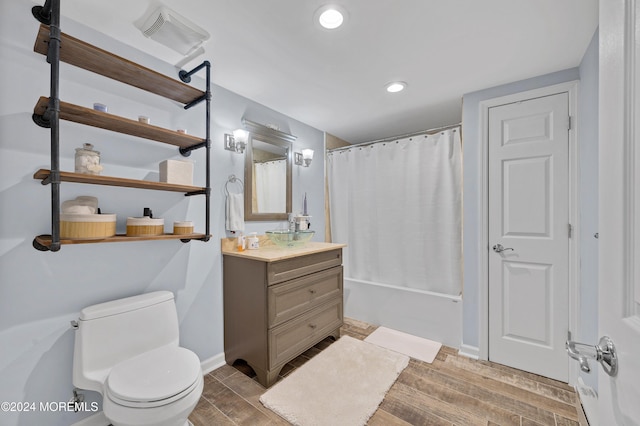 full bathroom with hardwood / wood-style flooring, vanity, toilet, and shower / bath combo with shower curtain