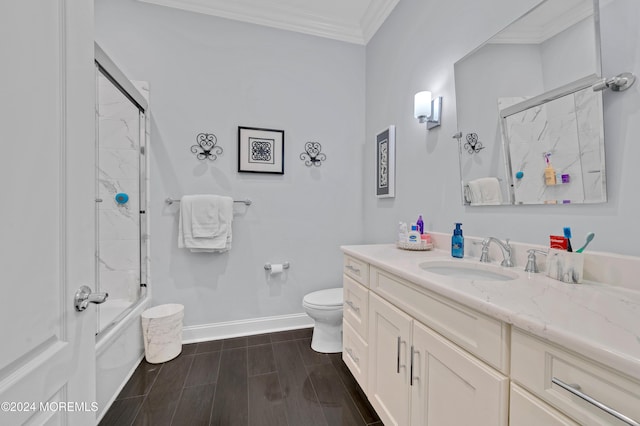 full bathroom with crown molding, vanity, enclosed tub / shower combo, and toilet