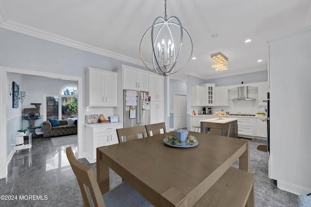 dining space with crown molding and an inviting chandelier