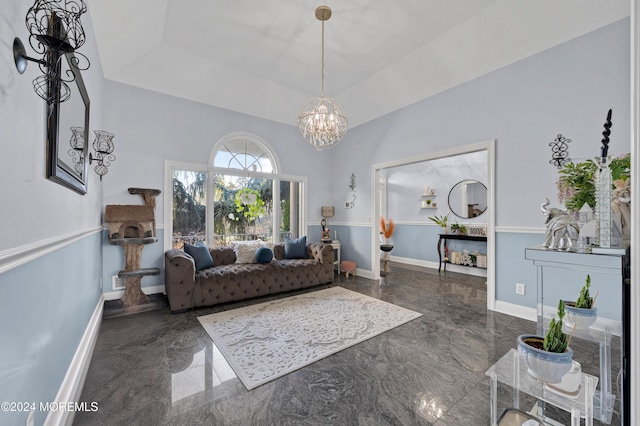 living room featuring a raised ceiling and a chandelier