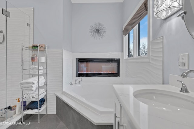 bathroom featuring tile patterned flooring, shower with separate bathtub, and vanity