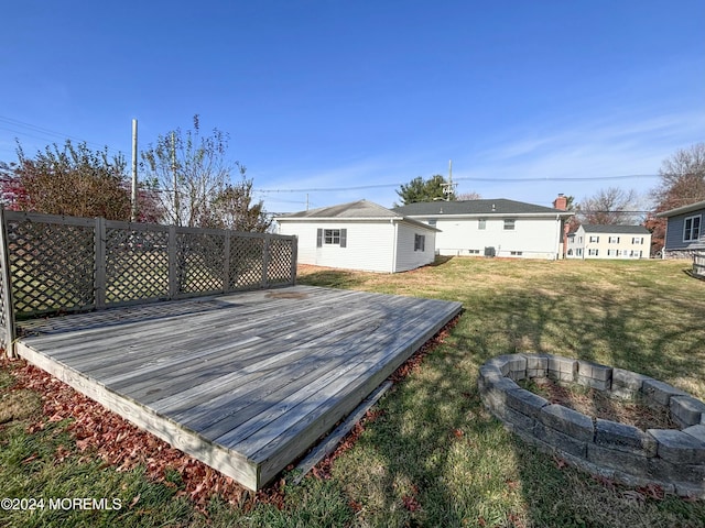 wooden terrace with a lawn