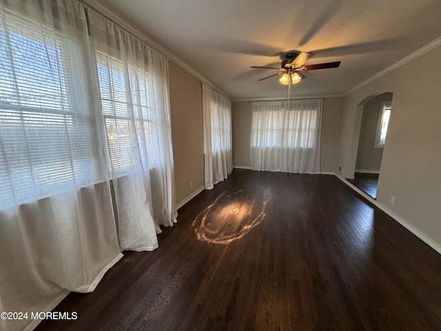 unfurnished room featuring ceiling fan, dark hardwood / wood-style flooring, and crown molding