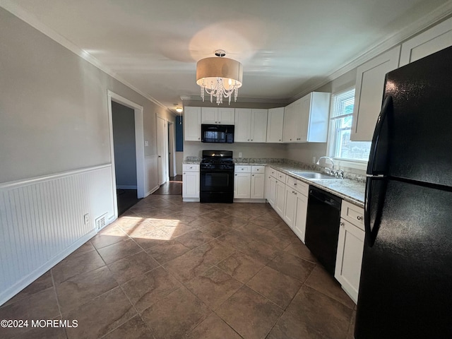 kitchen featuring white cabinetry, sink, a notable chandelier, black appliances, and ornamental molding