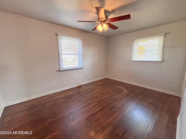 empty room featuring ceiling fan and dark hardwood / wood-style floors