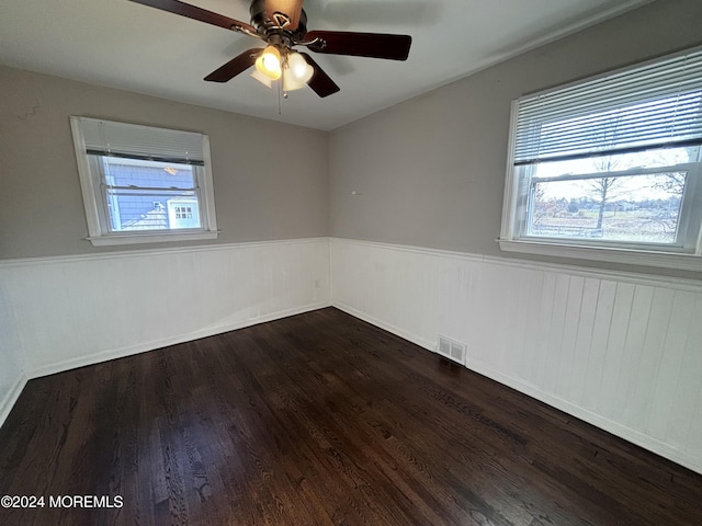 unfurnished room featuring ceiling fan and dark wood-type flooring