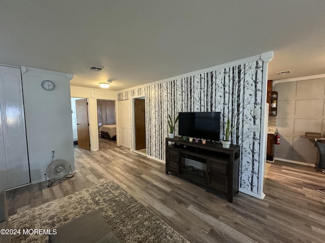 living room featuring crown molding and hardwood / wood-style floors