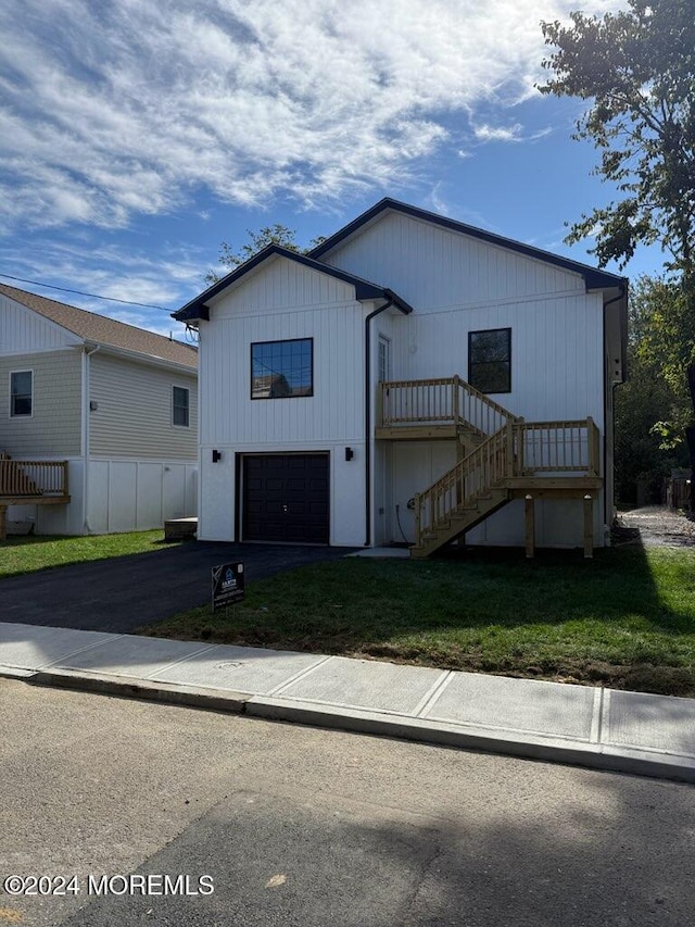 modern inspired farmhouse with a front yard and a garage