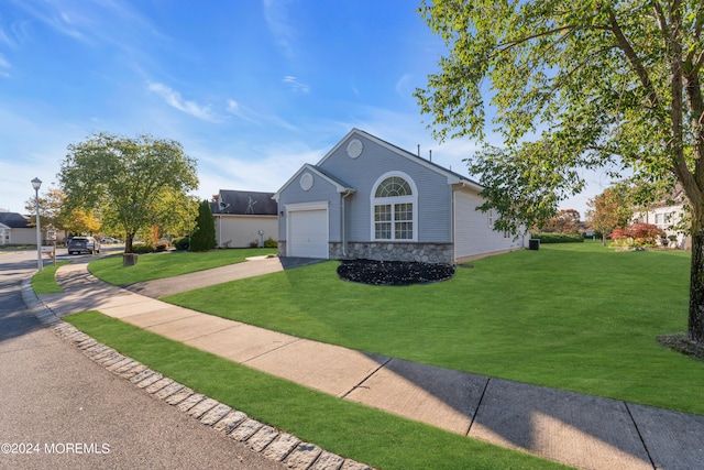 ranch-style home with a front lawn and a garage