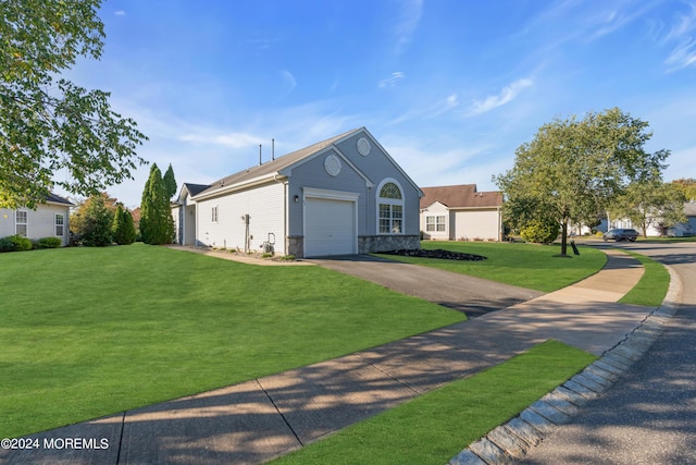 view of front of home with a front yard and a garage