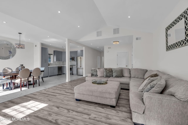 living room featuring light hardwood / wood-style floors and lofted ceiling