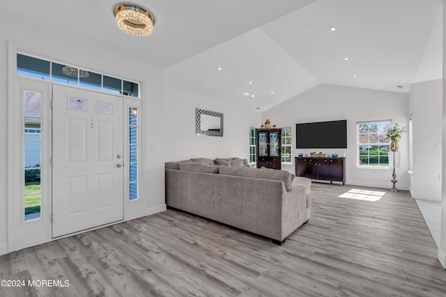 living room featuring light hardwood / wood-style floors and vaulted ceiling