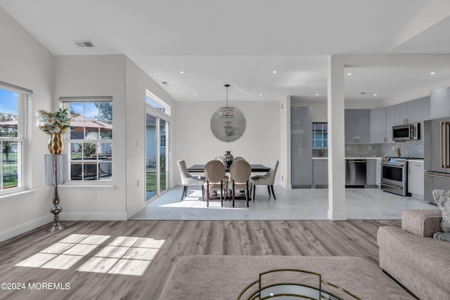 dining area featuring an inviting chandelier and light hardwood / wood-style flooring