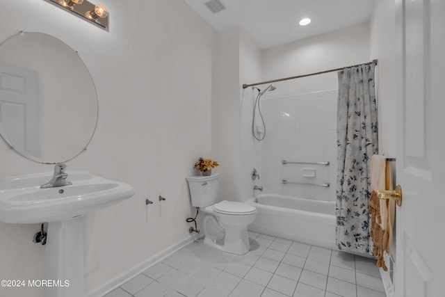 bathroom featuring tile patterned flooring, shower / bath combination with curtain, and toilet